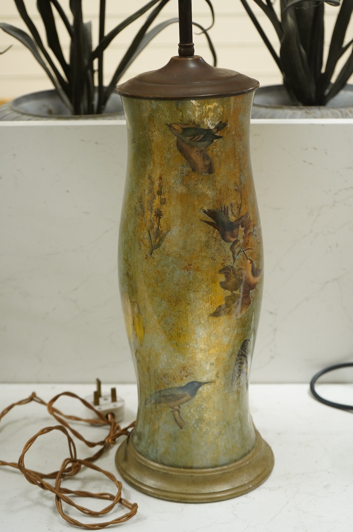 A pair of table lamps and shades, 92cm high, the lamps decorated in gold and green tones painted with birds and flowers, together with a small glass and brass hall lantern (3).